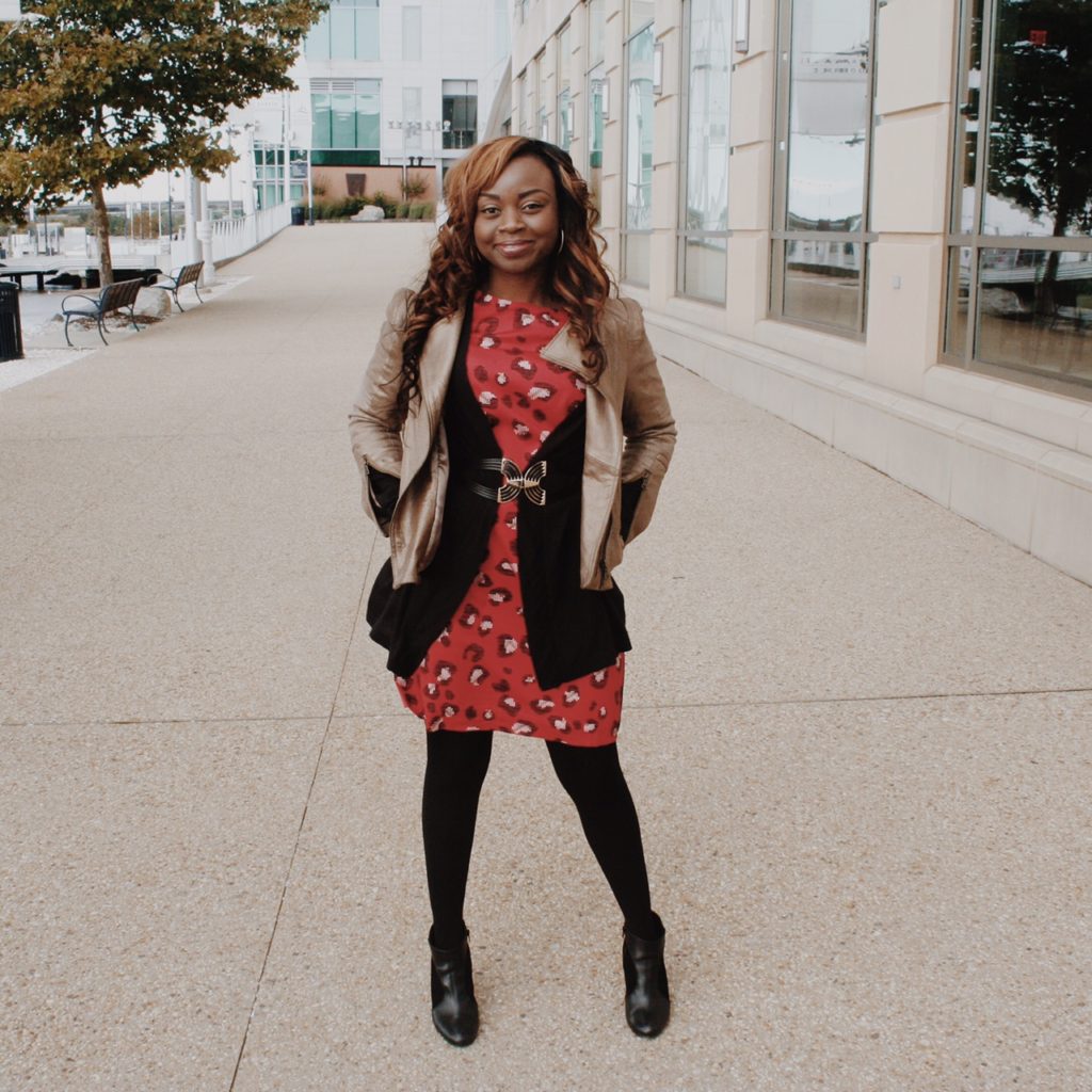 Red print dress with black sweater and leather jacket 1