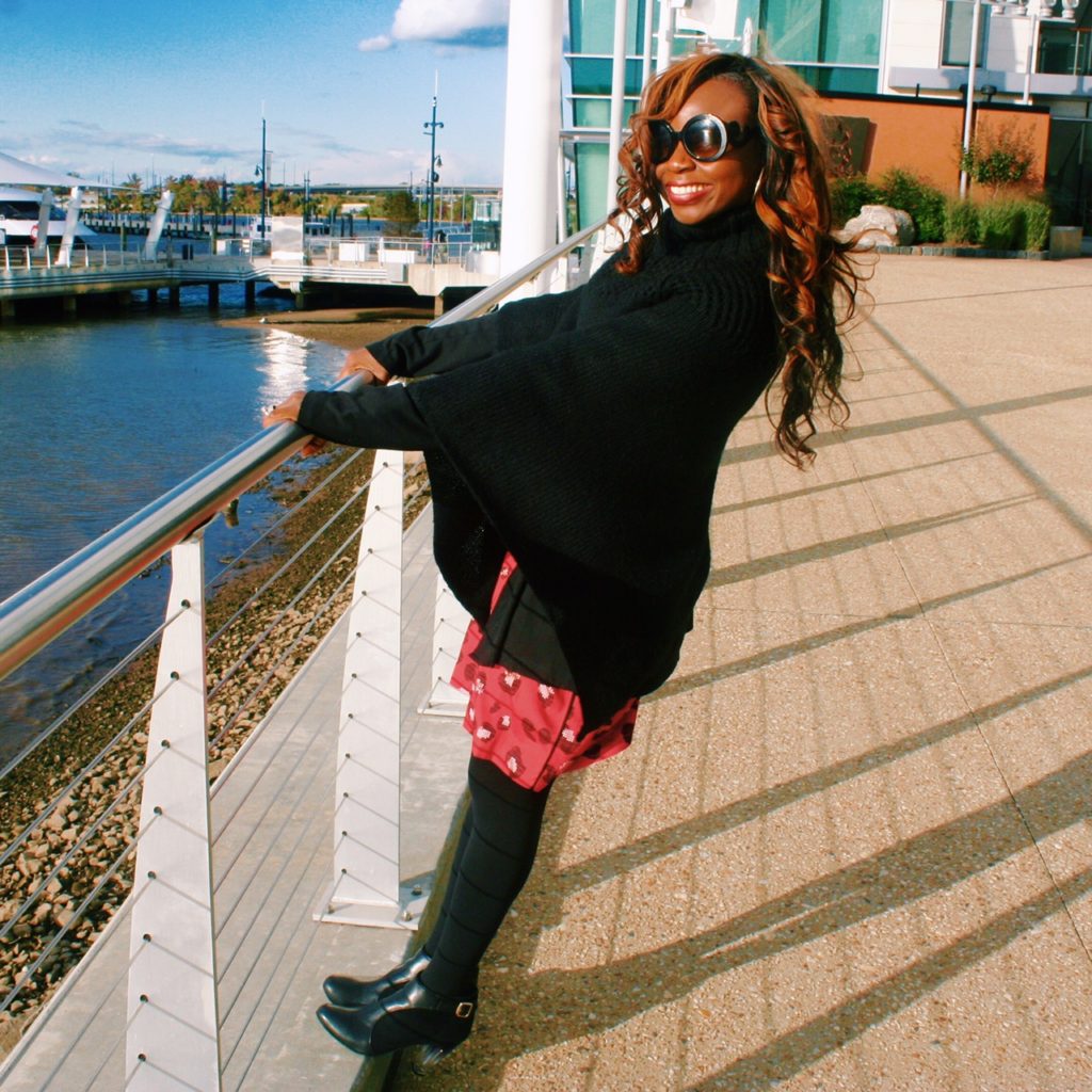 Red print dress, black sweater and poncho