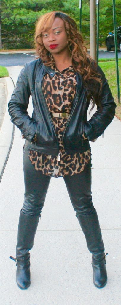 Long sleeve animal print top, gold belt, black leather pants, black leather jacket