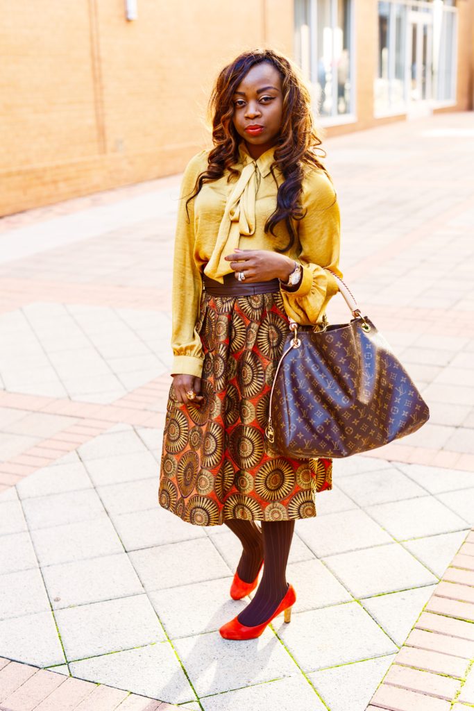 Gold-orange-print midi circle skirt-gold-pussybow-blouse-LouisVuittonbag-Orangepumps