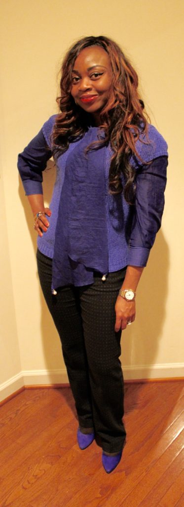 Blue blouse and sweater with black print pants and blue pumps