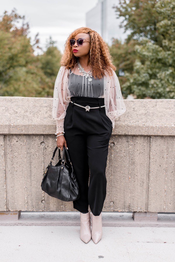 black lady in sheer long sleeve pink top