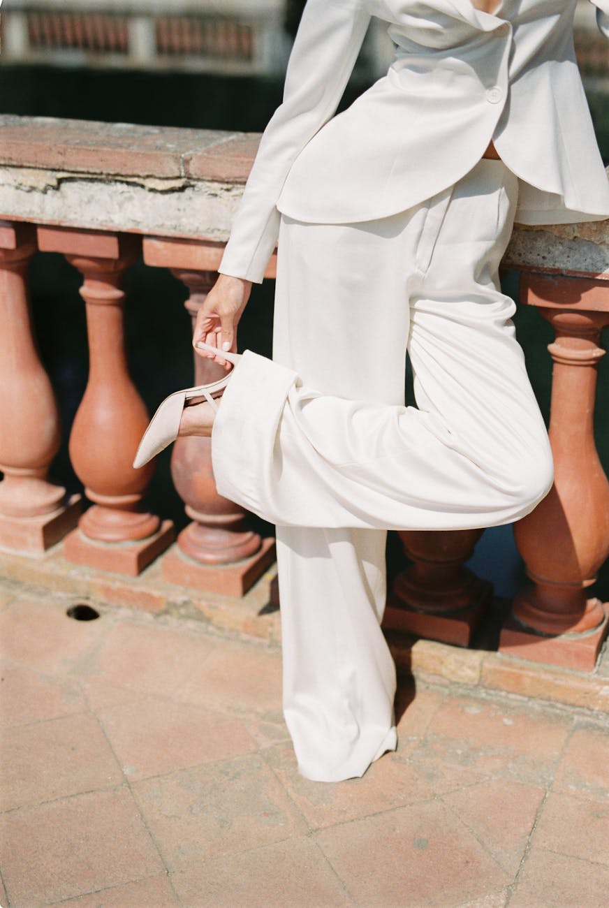 woman in white long sleeves top and white wide leg trouser